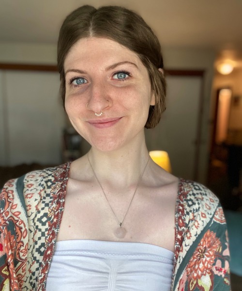 Leslie Wooten Photo shows a freckled woman with brown hair and blue eyes.
