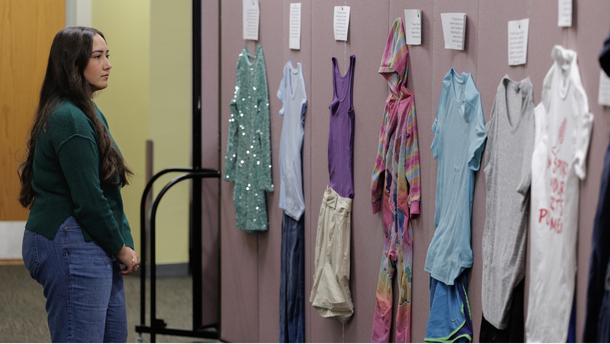 Alyssa Diaz stands in front of the What Were You Wearing display