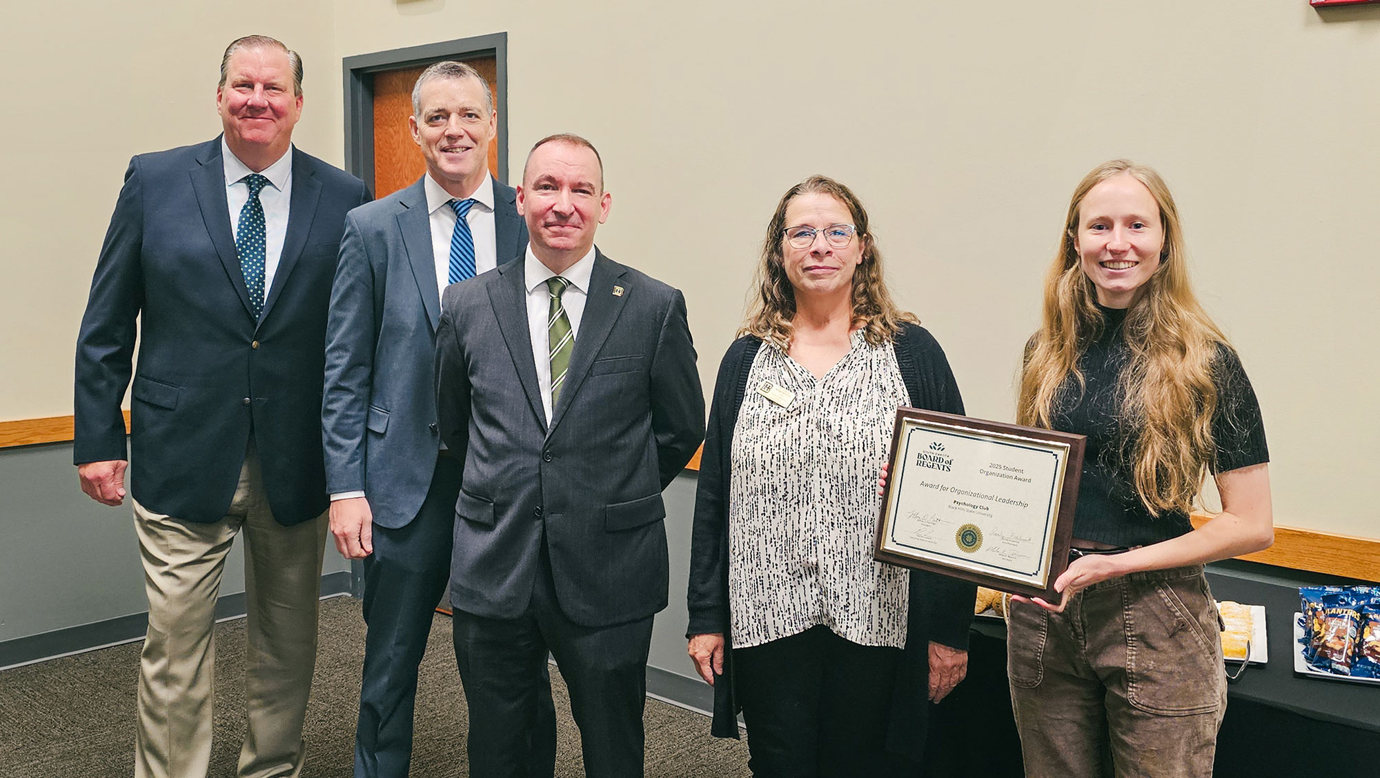 Psychology Club representatives and university leaders pose with the South Dakota Board of Regents Organizational Leadership Award at Black Hills State University.