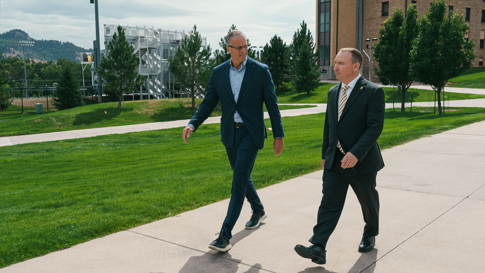 U.S. Senate Majority Leader John Thune and Black Hills State University President Steve Elliott walk across the BHSU campus during Thune's visit to the University.