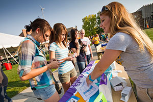 Four students check out a booth at the Student Organization Fair.