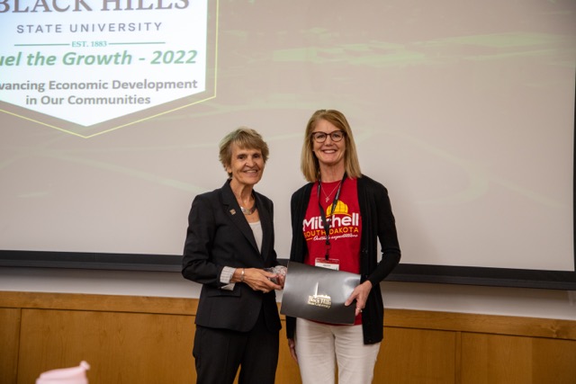 President Laurie Nichols giving award to recipient