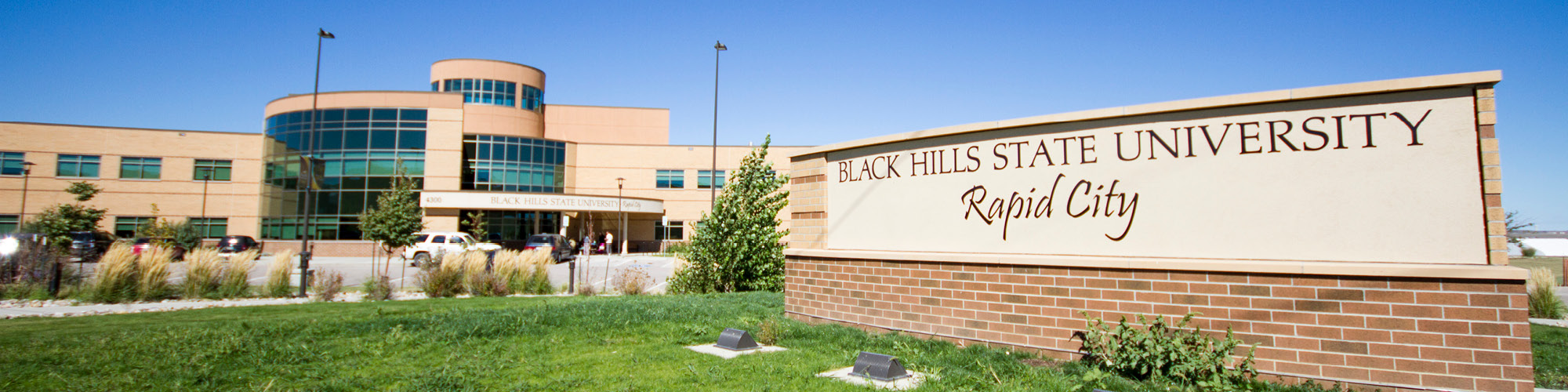 BHSU Rapid City College sign with building in background.