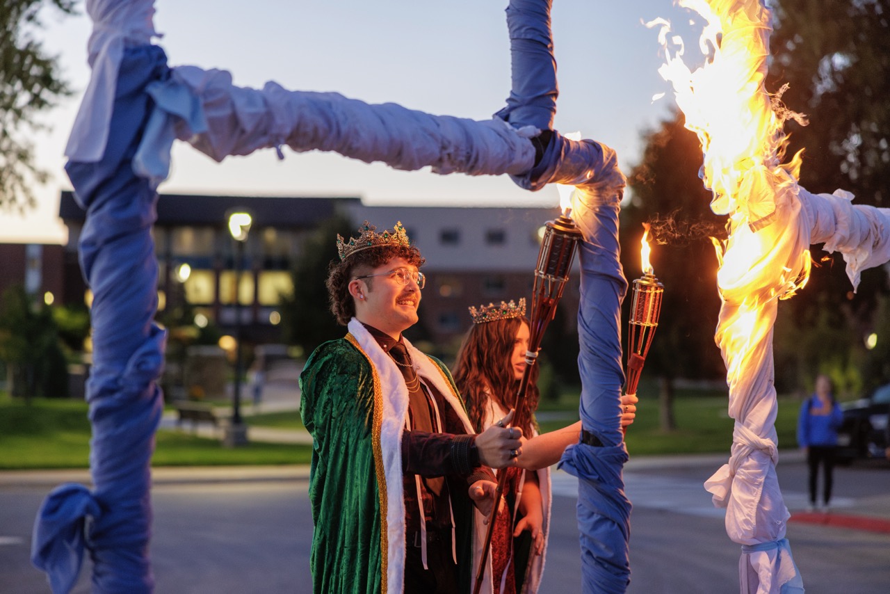 The BHSU homecoming king and queen setting a giant BH on fire as is the tradition during Swarm Days.
