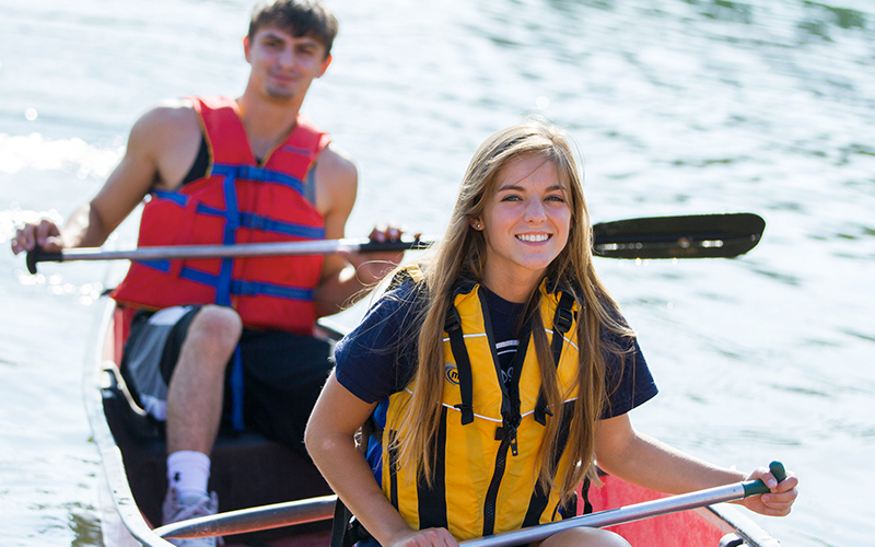 Two students kayaking. 