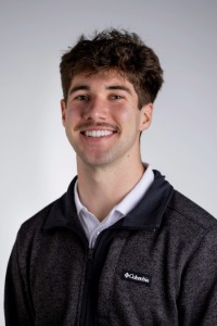 connor-hutcheson Graduate Connor Hutcheson smiles in his portrait