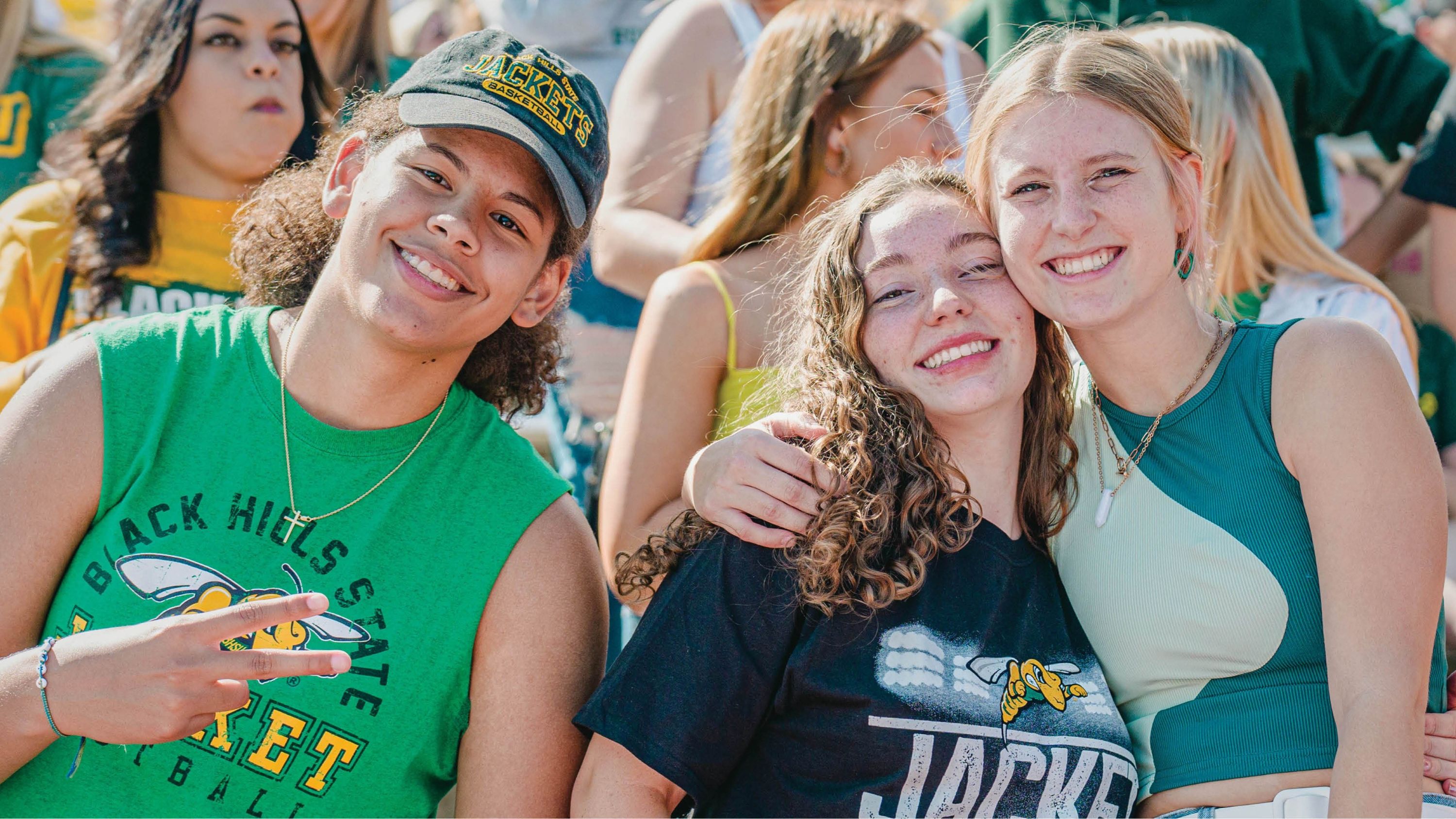Three BHSU students pose for a photo together at a BHSU football game